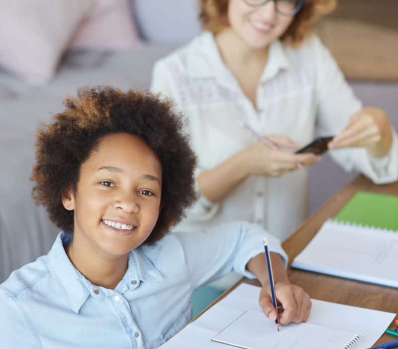 radiate-happiness-happy-mixed-race-teen-schoolgirl-smiling-at-camera-while-having-a-lesson-with.jpg